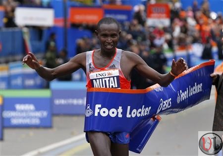 Geoffrey Mutai of Kenya crosses the finish line to win the men's division of the New York City Marathon
