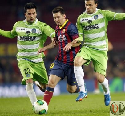 Barcelona's Messi fights for the ball against Getafe's Rodriguez and Leon during their Spanish King's Cup match at Camp Nou stadium in Barcelona