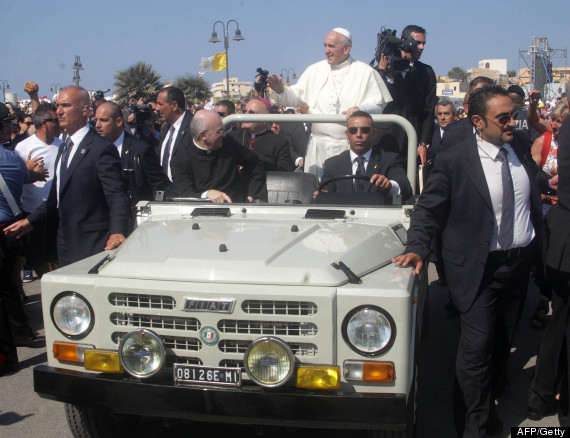 Poep Francis (C) waves to faithful as he arrives to lead a mass during his visit to the island of Lampedusa, a key destination of tens of thousands of would-be immigrants from Africa, on July 8, 2013. Pope Francis called for an end to "indifference" to the plight of refugees on Monday on a visit to an Italian island where tens of thousands of migrants from Africa and the Middle East first reach Europe.  AFP PHOTO / MARCELLO PATERNOSTROMARCELLO PATERNOSTRO/AFP/Getty Images