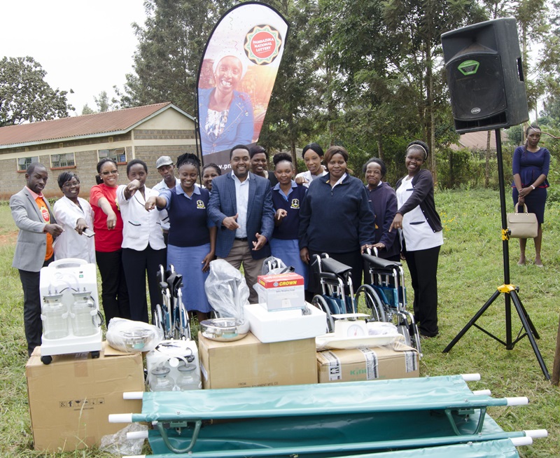 : Maragua District Level 4 District hospital staff receiving the medical equipment from the Pambazuka National Lottery team. 